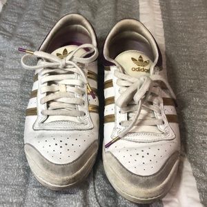Gold and purpled adidas shoes